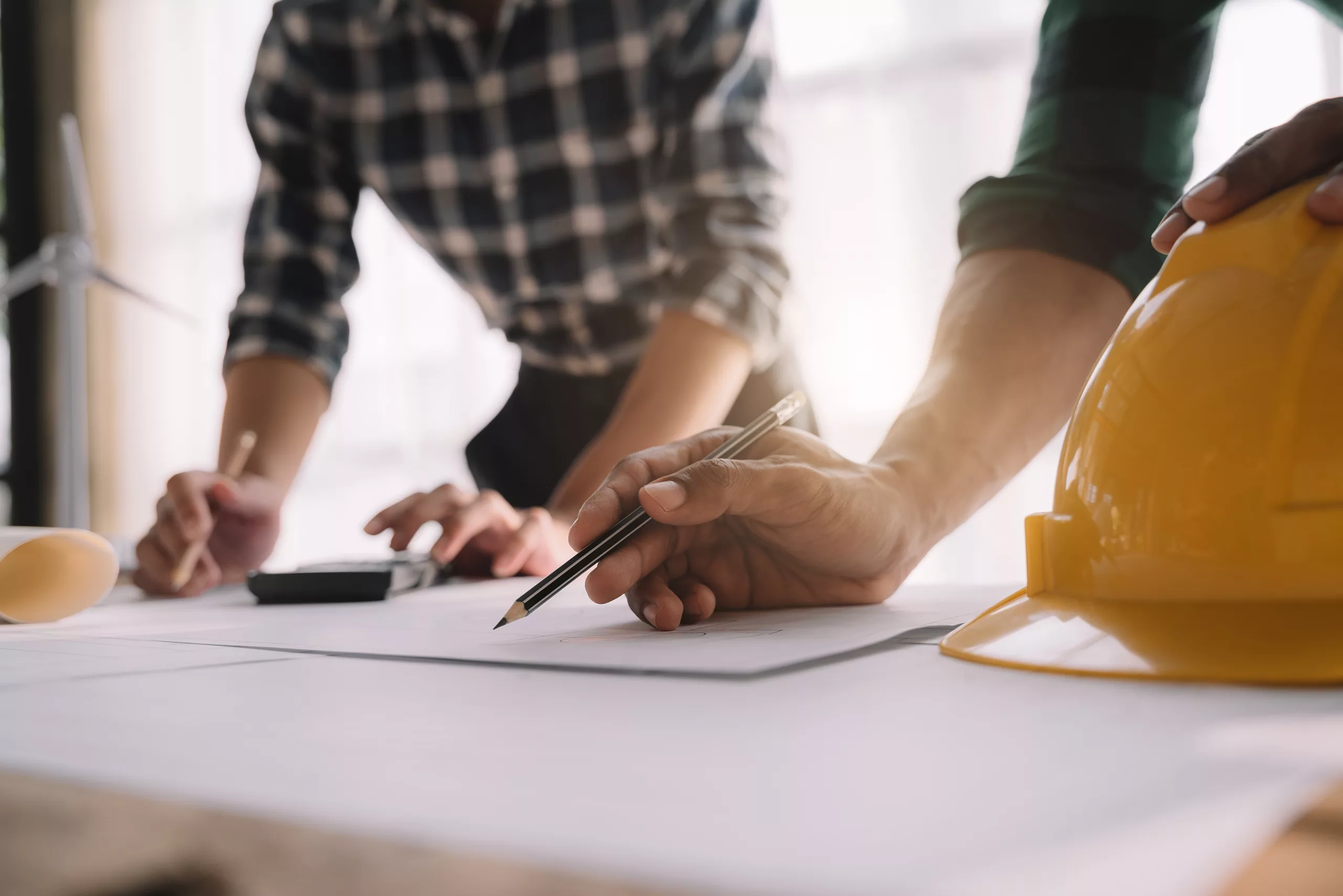 architect or engineer working on table use drawing tool on the paper plan for business architectural project.